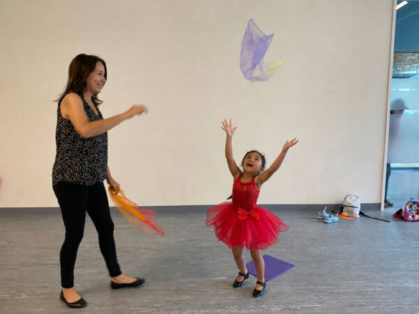 Lisa Esposito owner of Evolution Dance Center in Carlsbad, working with a child.