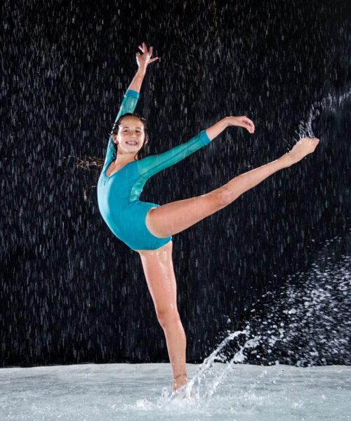 Theater Young girl dancing on water on stage in a theater dance taught at Evolution Dance Center in Carlsbad, CA