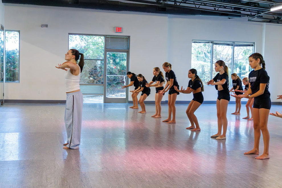 Woman dance instructor teaching young girl dance at Evolution Dance Center Carlsbad.