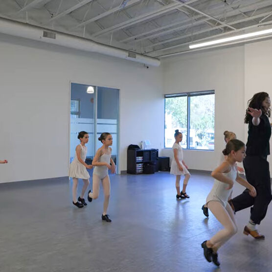 Dance instructor teaching young girls tap dance at Evolution Dance Center Carlsbad